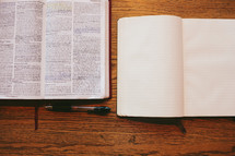 open Bible, open journal, and pen 
