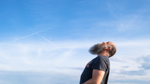 a man looking up at the sky 