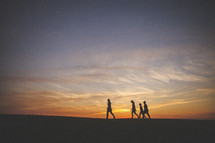 silhouettes of a family waling 