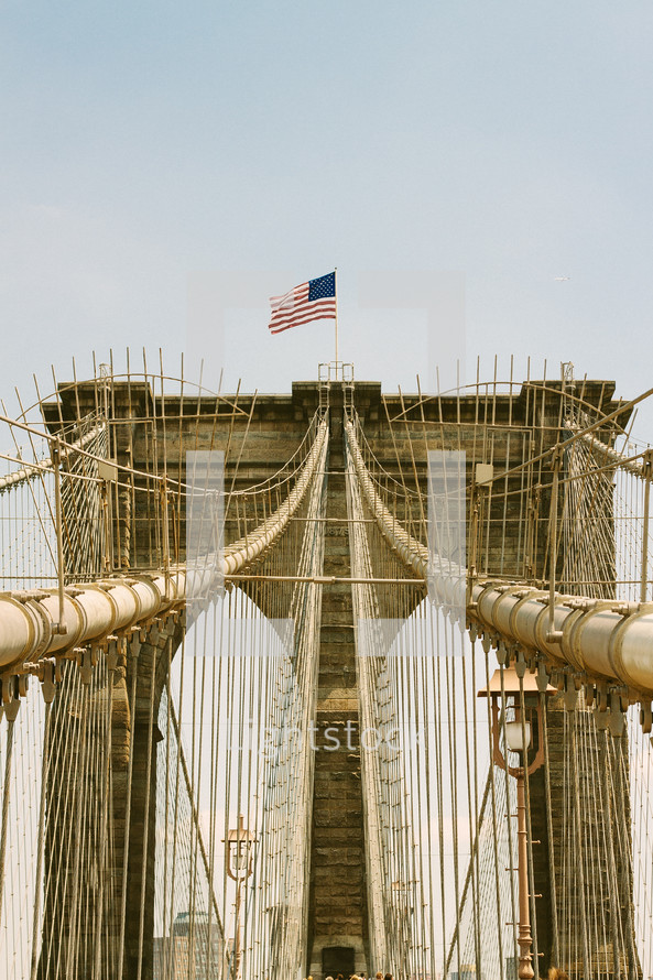 American flag and support cables on a bridge 