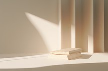 Minimalist scene with books, light and sunrays