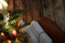 Bible under a decorated Christmas tree 