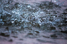 rain falling on choppy water 