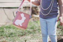 toddler girl holding an Easter basket 