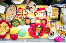 food and snacks on a table outdoors 