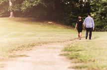 couple walking outdoors holding hands 