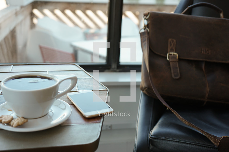 laptop and coffee cup and leather computer bag
