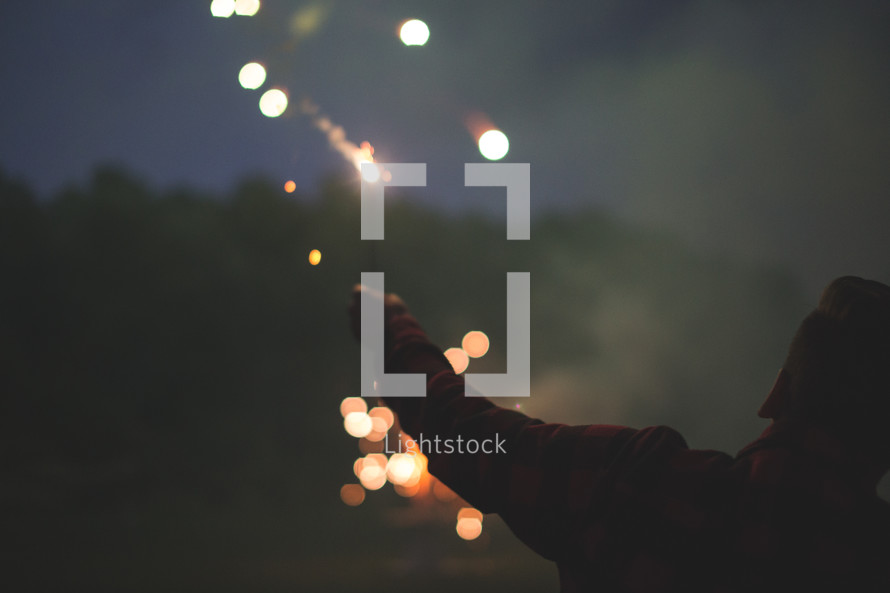 man holding fireworks 
