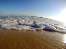 sea foam on the sands of a beach 