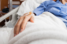 a woman with iv in a hospital bed 