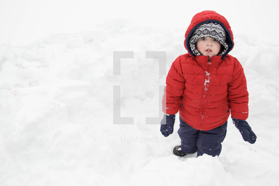 child playing in the snow 