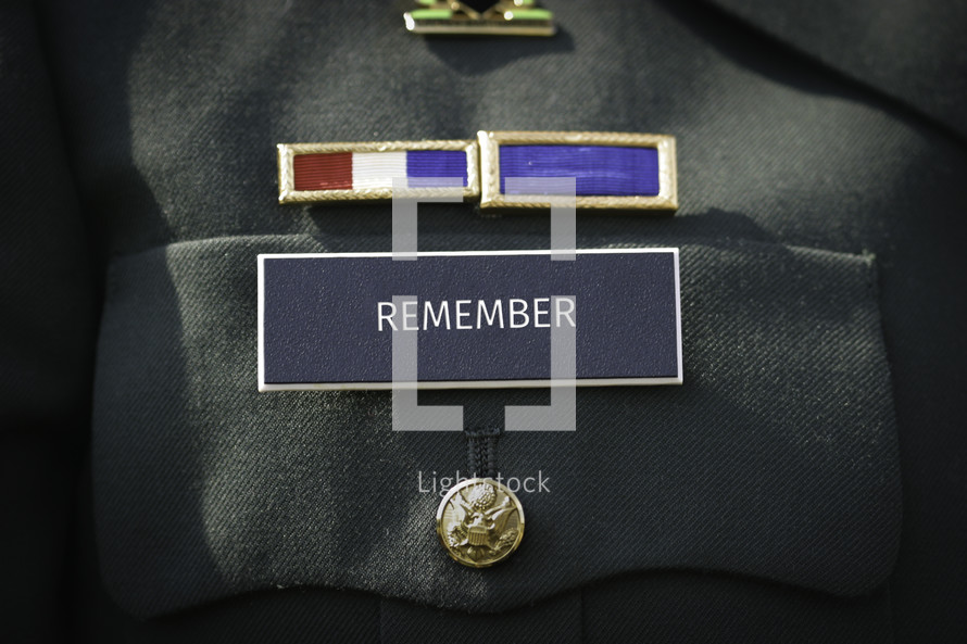 The word "remember" printed on the military name badge of uniform. 