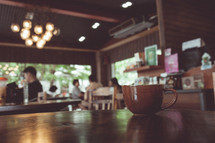 coffee mug on a table at a coffee shop 