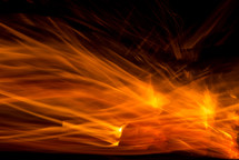 Orange flames, or light, on a black background.