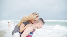 playful couple on a beach 