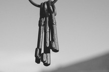 Old key ring hanging against the sky.