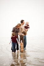 a family standing in the tide 