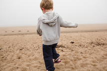 child walking in the sand on a beach 
