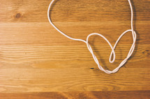 white cord in the shape of a heart 