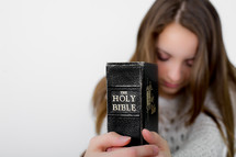 A teen girl holding a Bible 