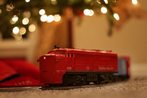 toy train under a Christmas tree 