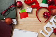 Christmas border on a desk with white paper notepad 
