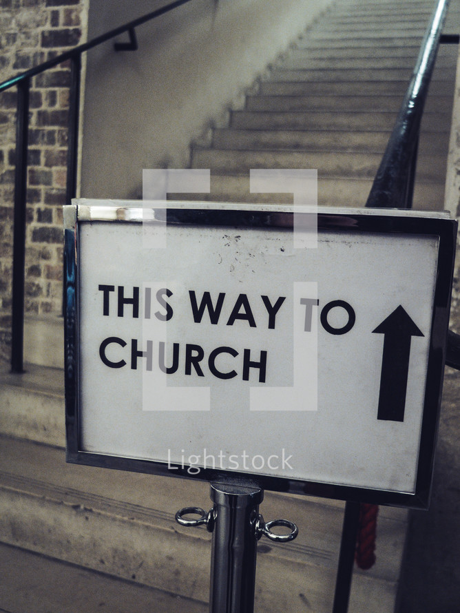 A sign saying 'This way to church'
