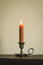 burning orange candlestick 