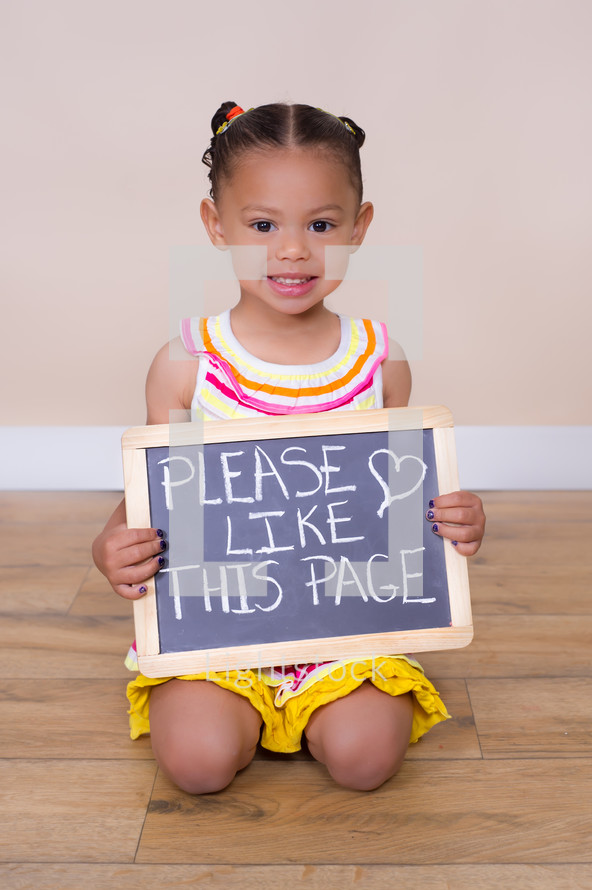little girl holding up a sign that reads please like this page