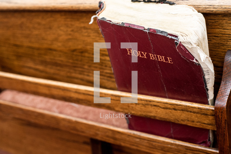 Bible on a church pew.