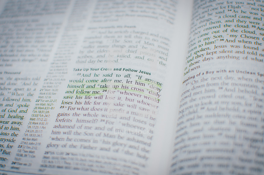 A bible opened up to a gospel passage highlighted in green entitled 'Take up your cross and follow Jesus'.