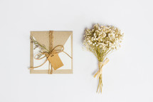 envelope and bouquet of dried flowers 