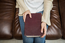 a woman sitting with a Bible in her lap 