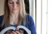 A woman reading from a Bible 