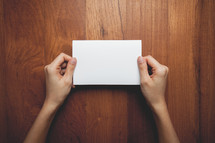 hands holding a blank envelope 