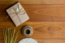 wrapped brown paper gift box and fuzzy grasses