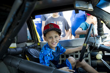 child in a Nascar vehicle 
