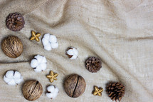 cotton and pine cone on burlap 