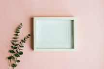 blank frame and green leaves of plants 