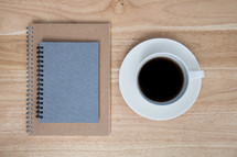spiral notebooks and coffee cup 