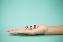 hand holding the word God