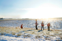 kids playing in snow in a field 