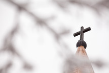 cross topper on top of a church steeple