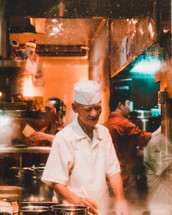 man cooking in a restaurant kitchen 