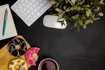 computer keyboard and mouse with coffee and donut 