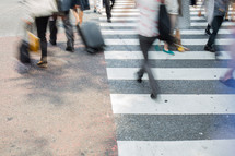 blur of people crossing a crosswalk 