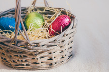 Colored easter eggs in a wicker basket