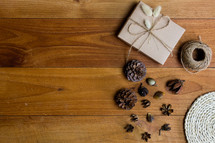 brown paper gift box and pine cones 