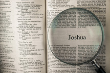 magnifying glass over Bible - Joshua 