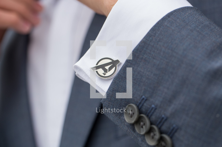 Avenger cuff link on a groom's sleeve 